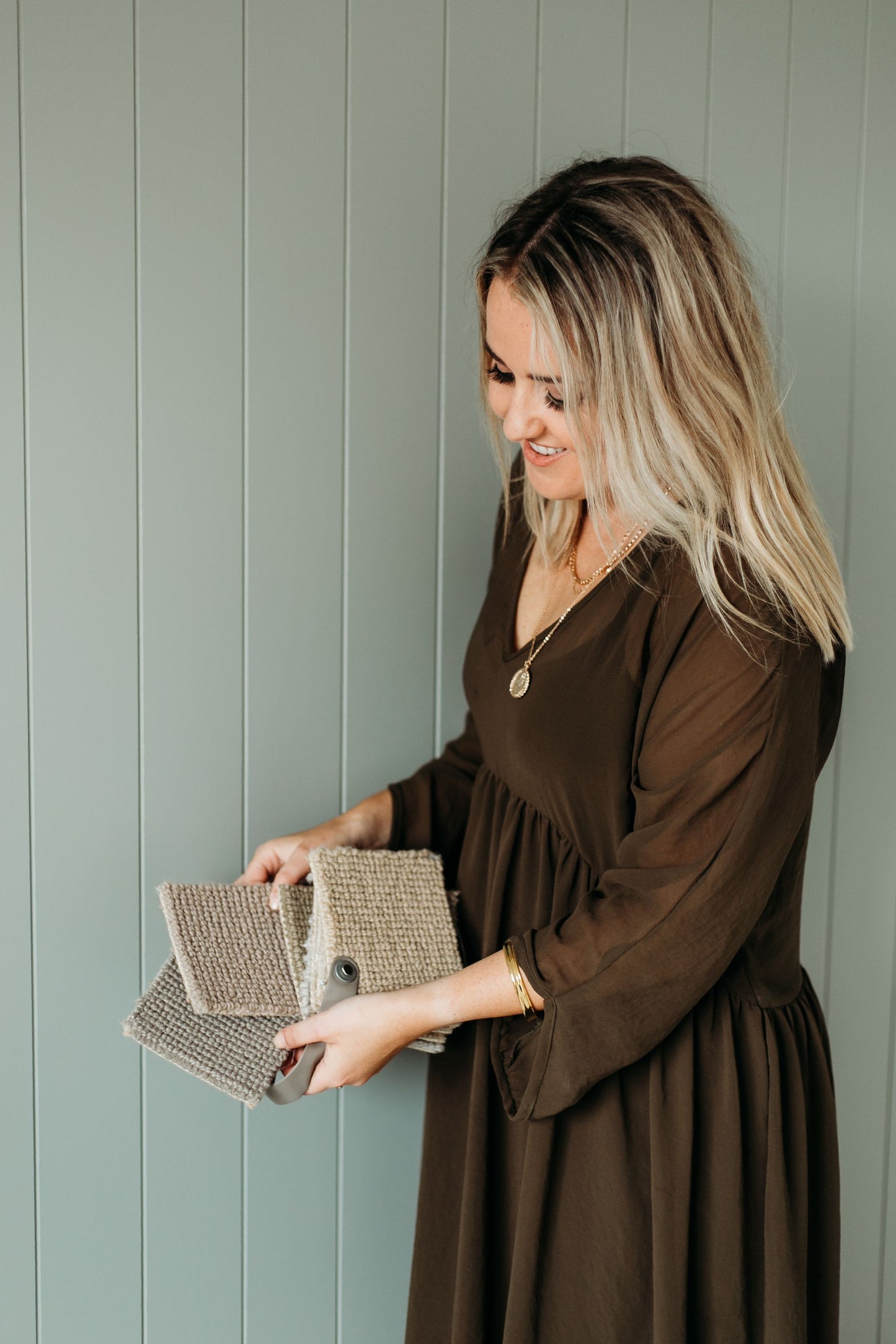 Colour speicalist and interior designer Lucy Furniss holds up carpet samples