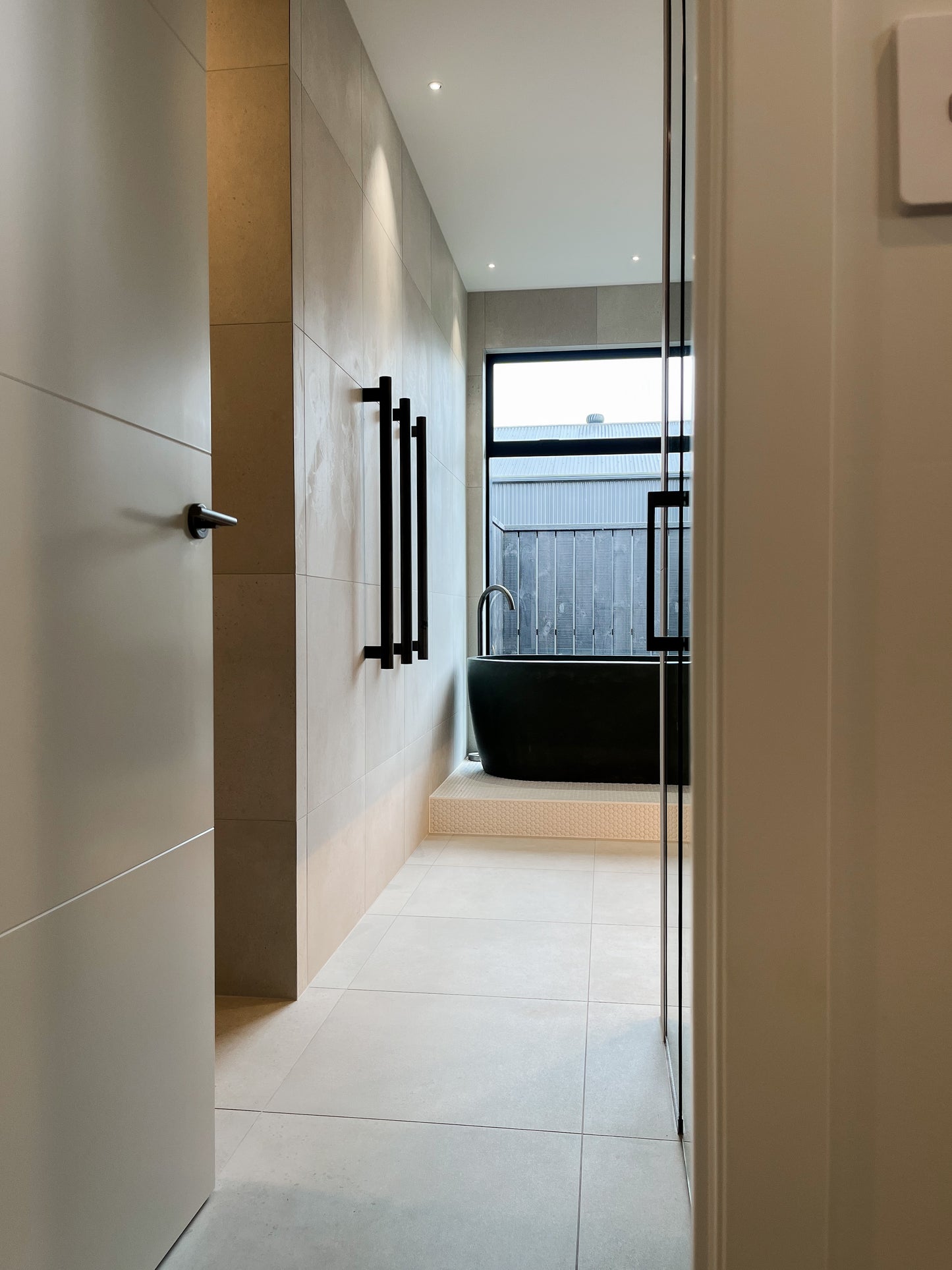 Modern, expansive bathroom designed by Interior Designer Lucy Furniss featuring negative toe kick and large joinery