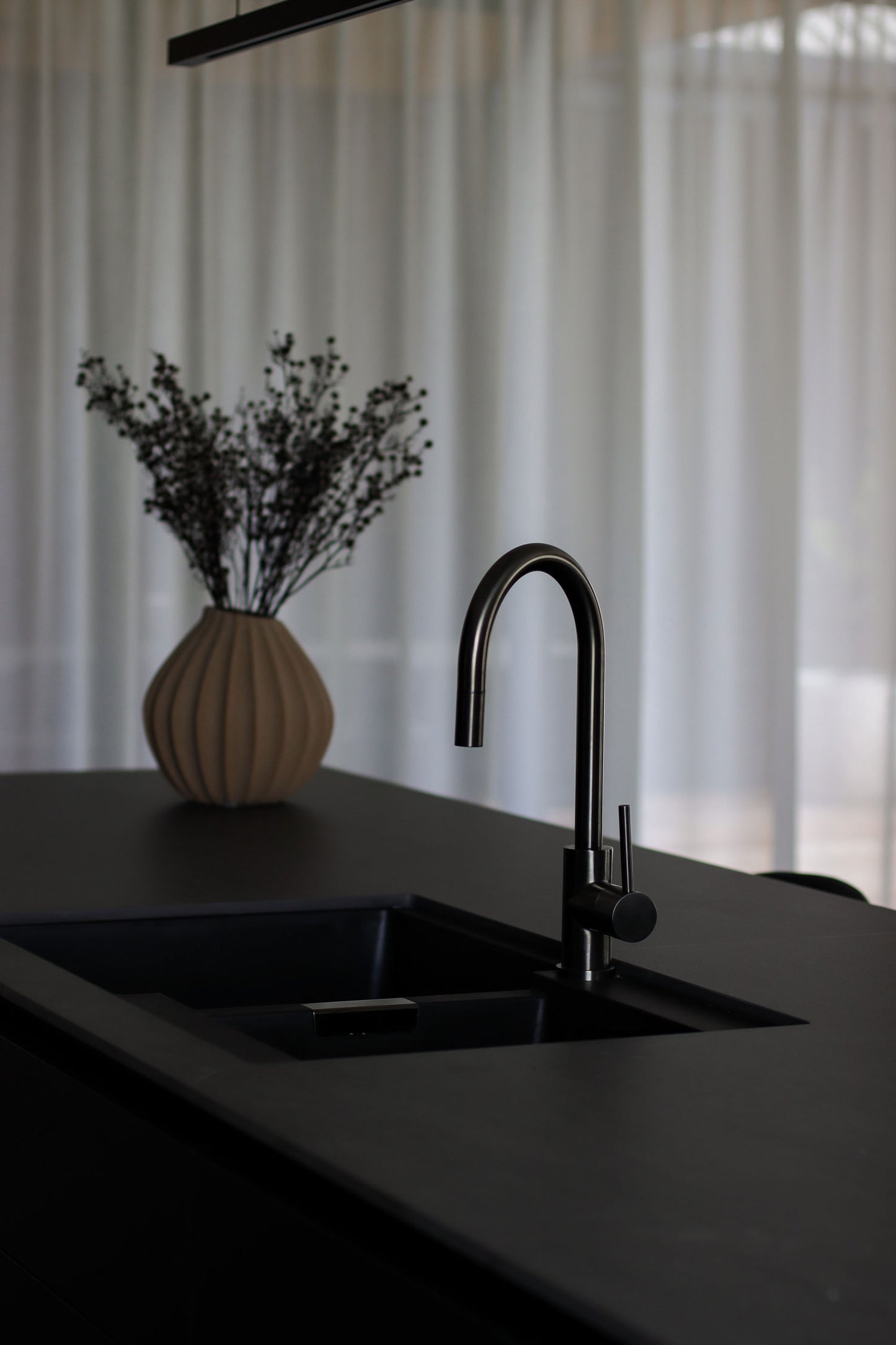 Sleek, black kitchen designed by NZ Interior Designer Lucy Furniss